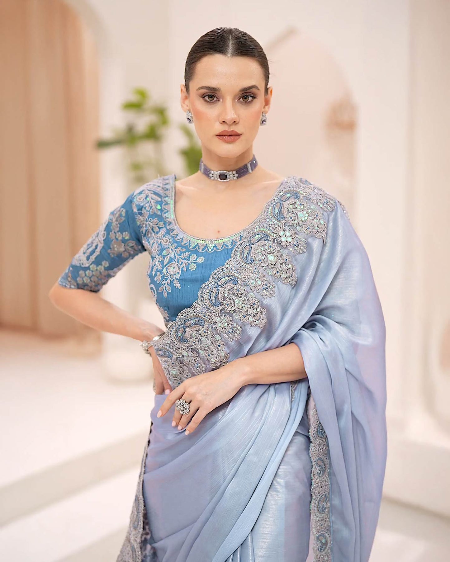 Powder blue silky shimmer georgette saree with metallic sheen and stone embroidery by Rinaz