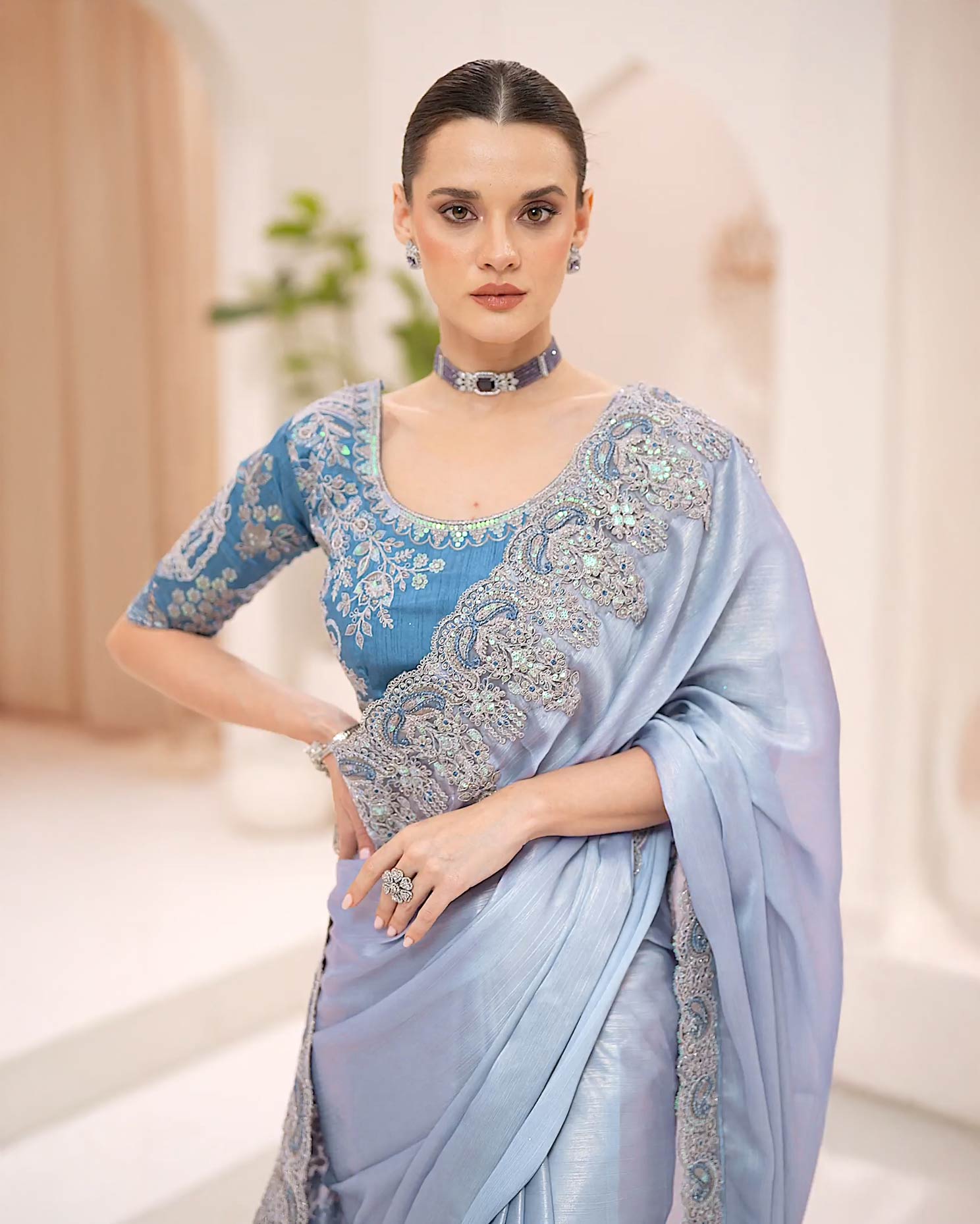 Powder blue silky shimmer georgette saree with metallic sheen and stone embroidery by Rinaz