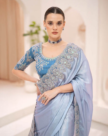 Powder blue silky shimmer georgette saree with metallic sheen and stone embroidery by Rinaz
